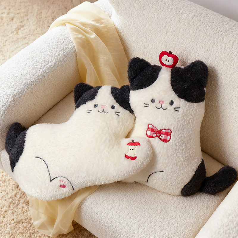 Apple cat plush pillows in lying and sitting styles with apple details, soft plush cat cushions placed on a cozy chair for warm home decor