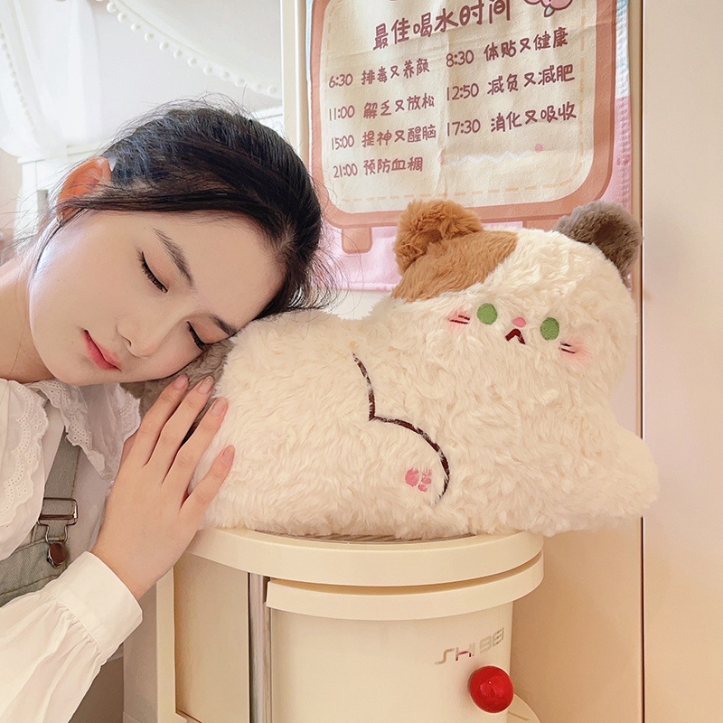 Calico cat plush pillow in lying style with soft fluffy texture, a cozy stuffed cushion ideal for hugging, napping, or decorating warm bedroom spaces