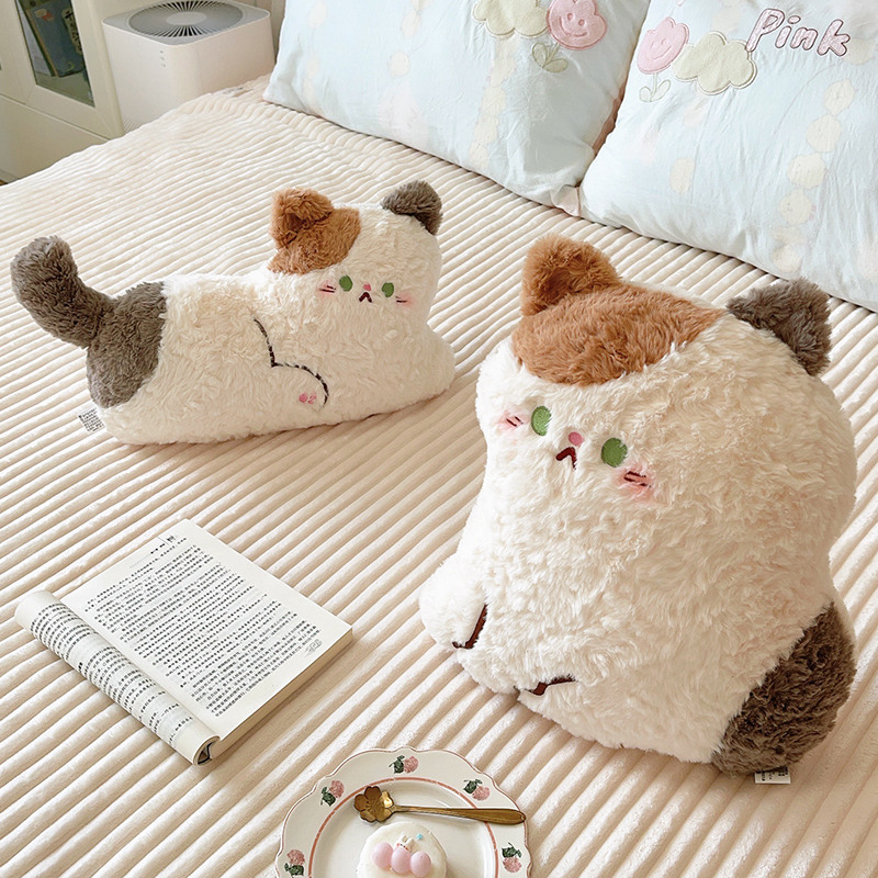 Cute calico cat plush pillows in sitting and lying styles placed on a bed, soft stuffed cushions perfect for hugging, relaxing, or decorating cozy bedroom spaces