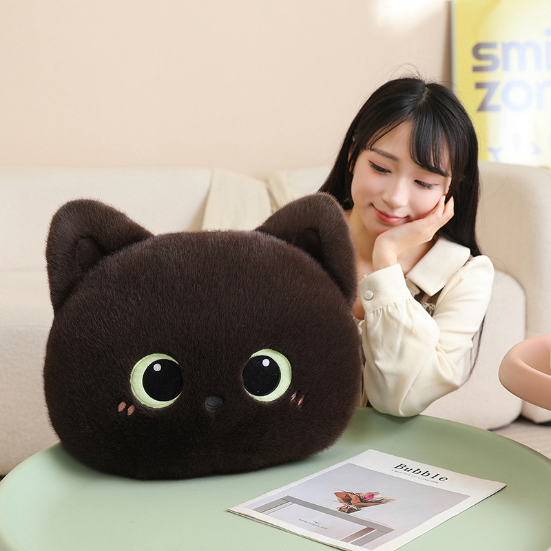 Brown cat head plush pillow with big eyes on a table in a cozy living room, soft fluffy cushion ideal for hugging, relaxing, or decorating sofas and beds