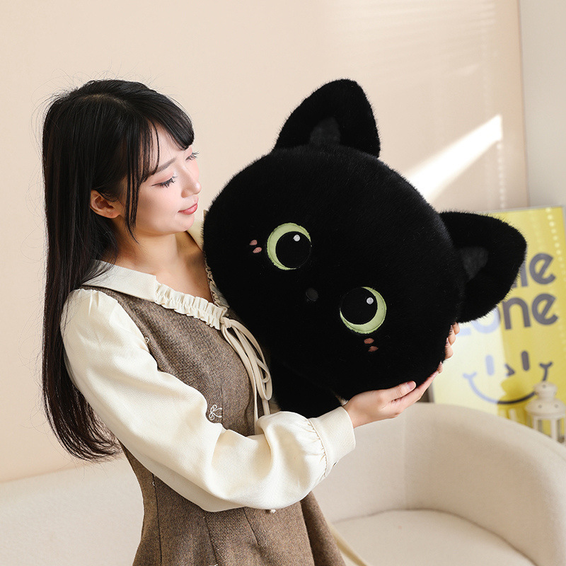 Black cat head plush pillow with big eyes being held, soft fluffy cat face cushion perfect for hugging, relaxing, and adding a cozy touch to living room decor