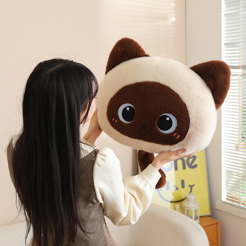 Siamese cat head plush pillow with soft fluffy texture and round shape, a cute cat face cushion designed for hugging, relaxing, and decorating sofas or bedrooms