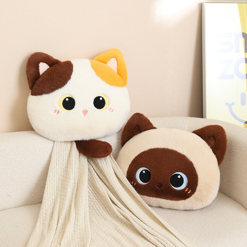 Cat head plush pillows in calico and Siamese styles on a cozy sofa, soft fluffy cushions with big eyes designed for hugging, relaxing, and decorating home spaces