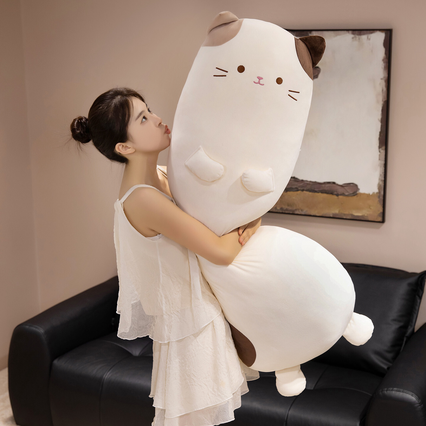 Calico cat long plush pillow used as a soft hugging body pillow, featuring a cute cat design and smooth plush fabric, ideal for cuddling, relaxing, and cozy home decor