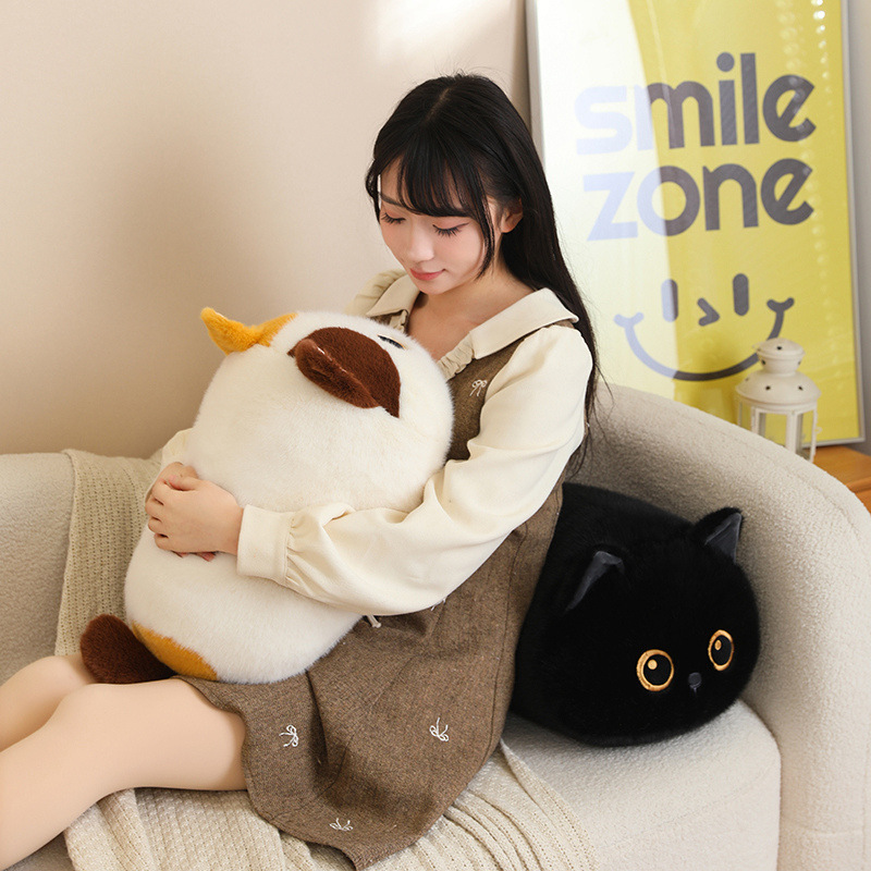 Bread cat plush pillows in calico and black styles on a sofa, soft round loaf-cat cushions for hugging, relaxing and cozy home decor