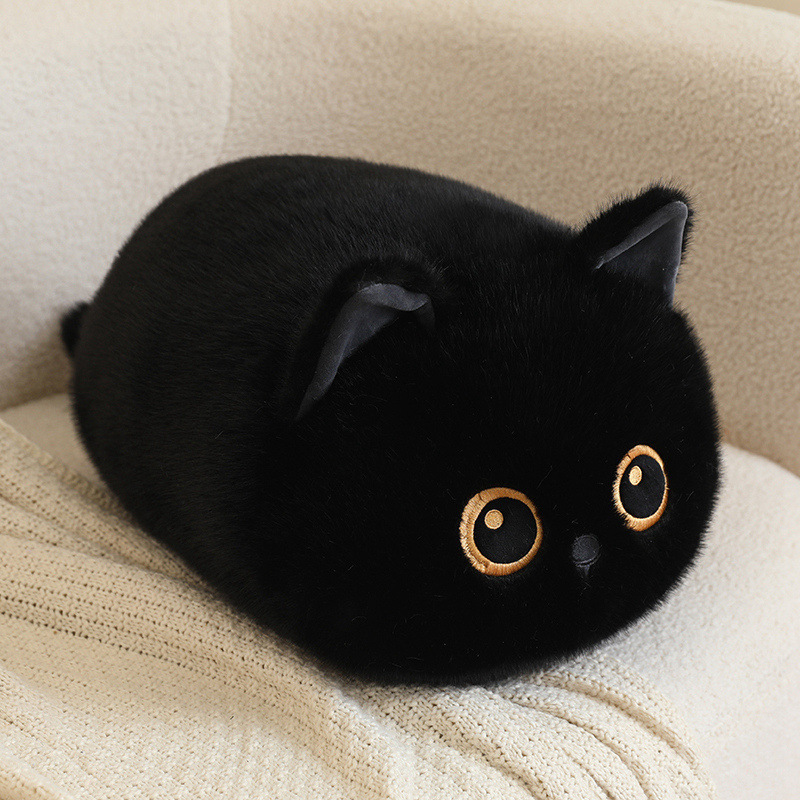 Black bread cat plush pillow with soft round loaf-cat shape and fluffy texture, cozy cat cushion for hugging and relaxing on a sofa