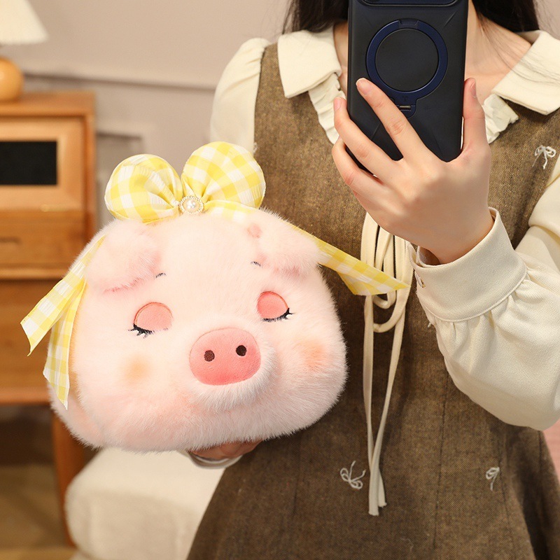 Fluffy pig plush toy with sleepy eyes and yellow bow, soft pink stuffed animal with cute round pig face design