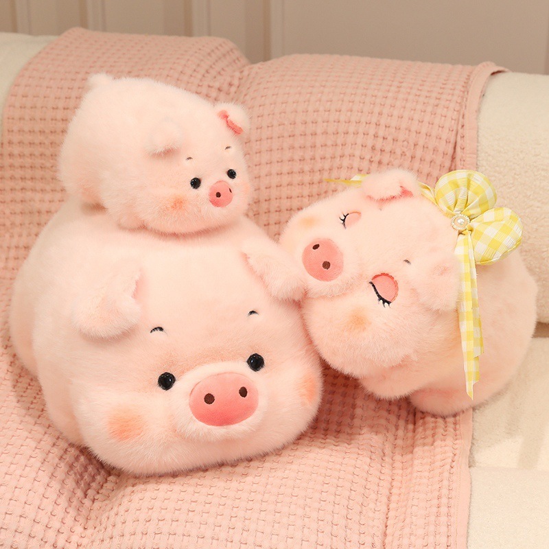 Fluffy pig plush toys in different sizes with soft pink fur and cute round pig face design displayed on a cozy sofa