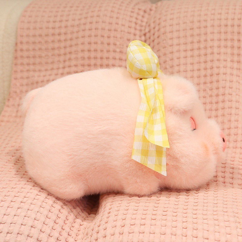 Fluffy pig plush toy with sleepy eyes and yellow bow detail, soft pink stuffed pig with round chubby body design