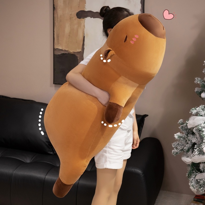 Capybara plush pillow hugged as a long body cushion, showing its soft, huggable design and full body comfort