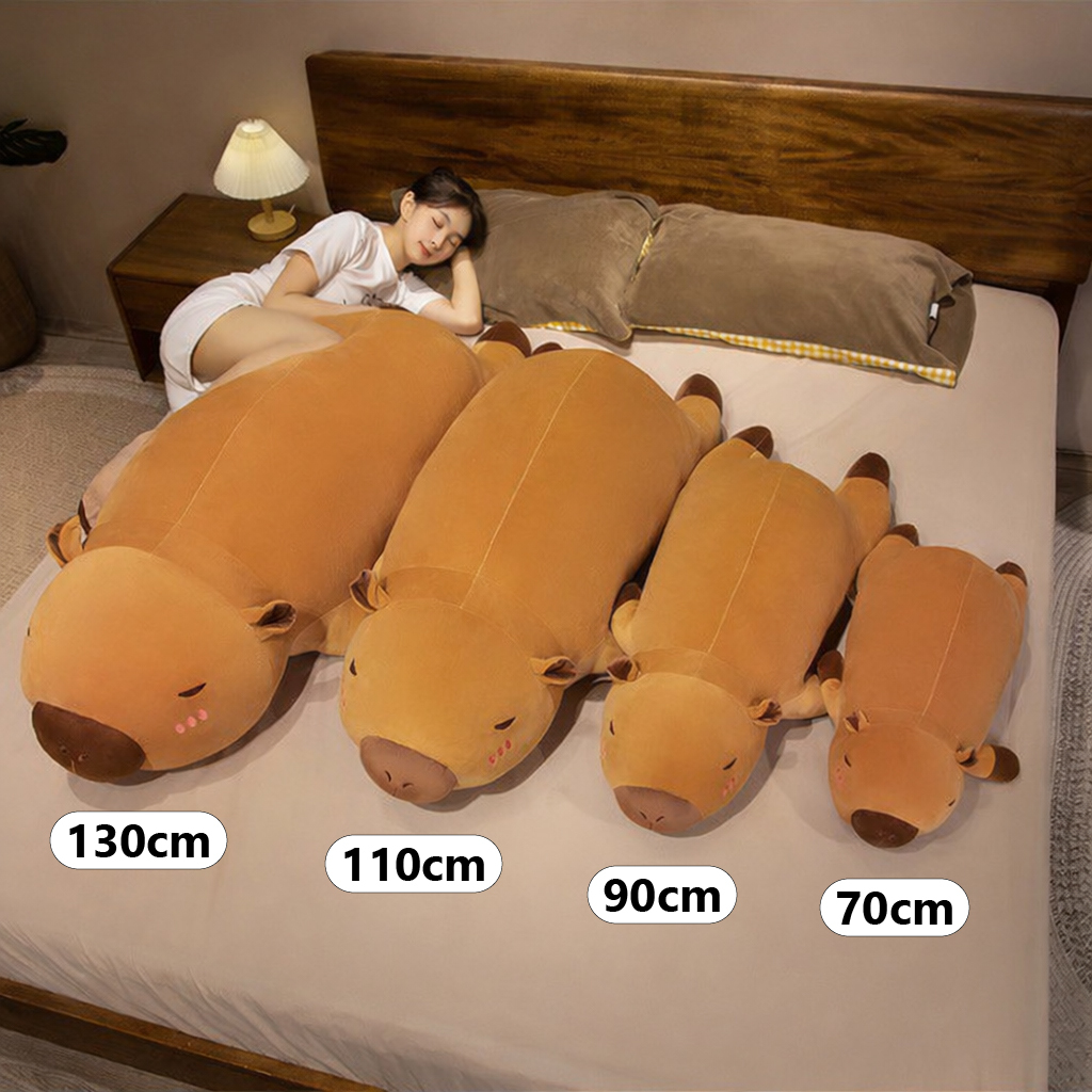 Capybara plush pillow size comparison showing 70cm, 90cm, 110cm, and 130cm long body pillows for hugging, sleeping, and cozy bed use