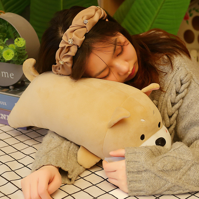 Khaki lying dog plush pillow used as a soft cushion for napping, cozy and supportive design perfect for relaxing moments and a calm home atmosphere