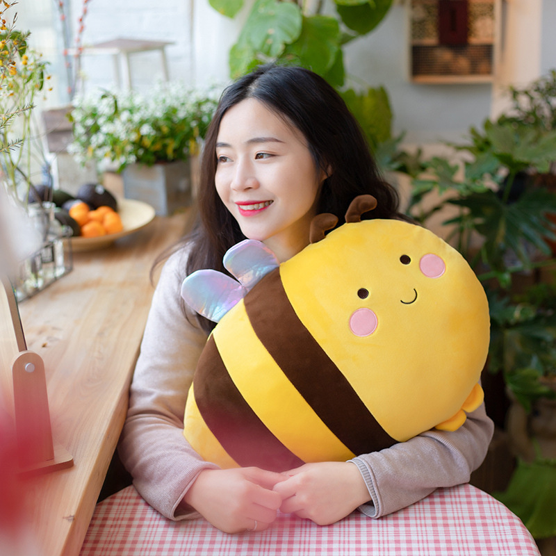 Bee plush pillow used as a soft hugging cushion, cozy and cute for relaxing moments and home comfort