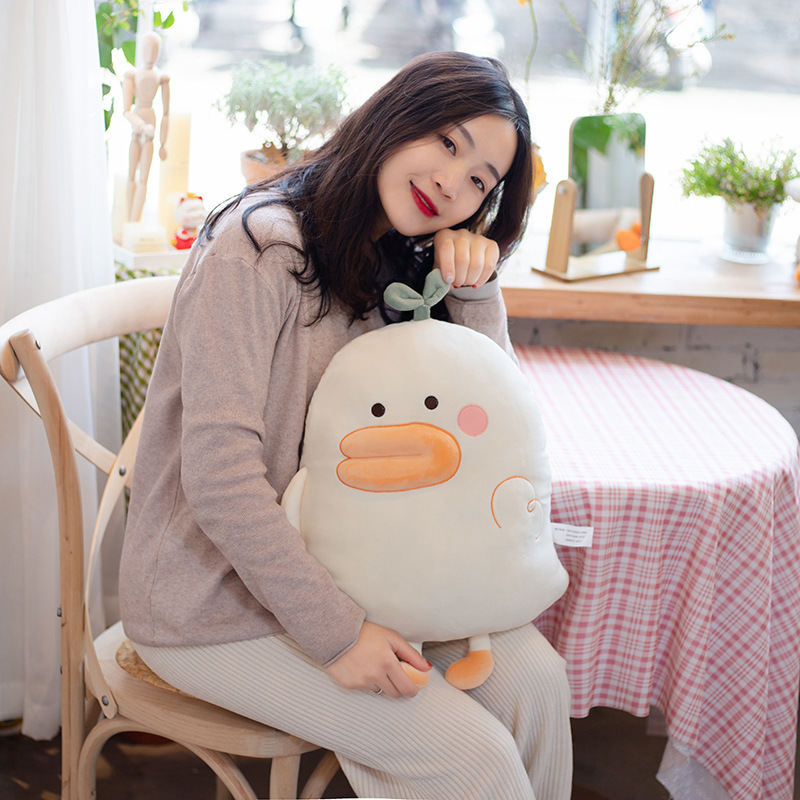 Duck plush pillow on a chair as a soft hugging cushion, ideal for home decor and comfortable lounging