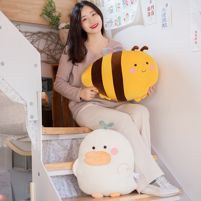 Duck and bee plush pillows on stairs as soft hugging cushions, perfect for cozy home decor and relaxing spaces