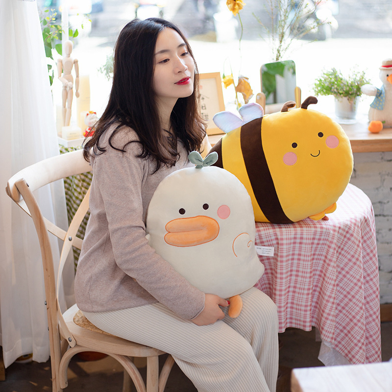 Duck and bee plush pillows used as soft hugging cushions, perfect for relaxing, napping, and cozy home comfort