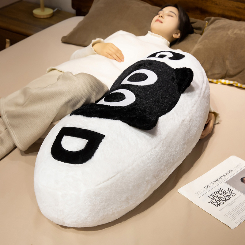 GOOD cat long plush pillow used as a full body cushion for lying down, providing soft support and comfort for resting and relaxing on bed