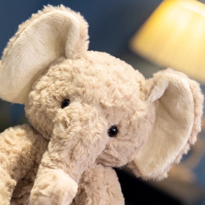 Close-up of elephant plush toy face with fluffy texture and gentle expression, designed for comfort and cuddling