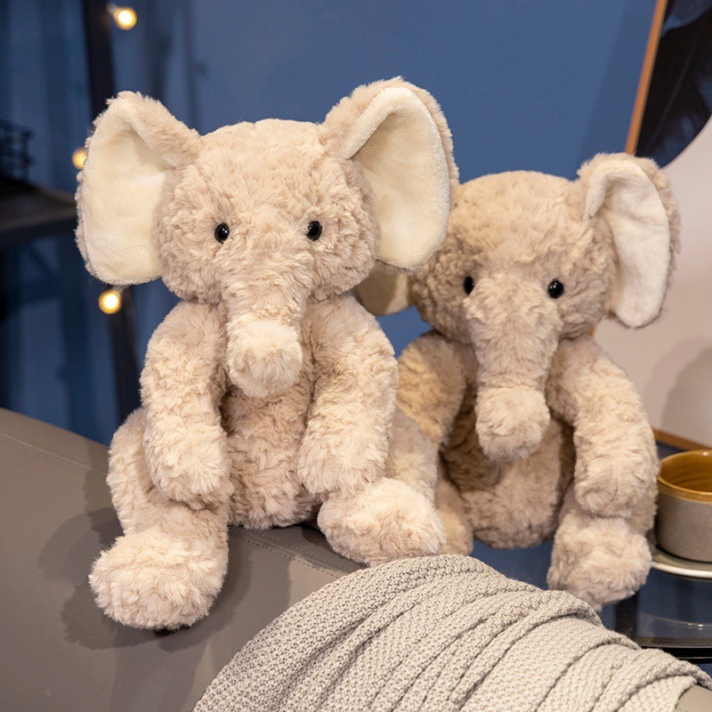 Cute elephant plush toys in sitting pose, displayed together as cozy decorative accents for sofas and home spaces