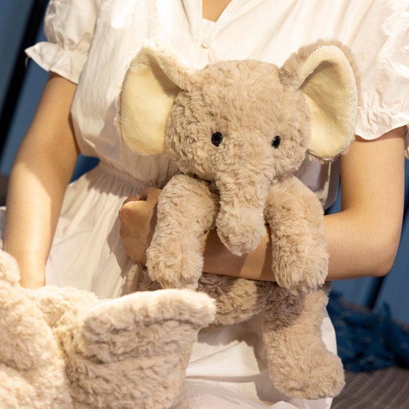 Soft elephant plush toy with fluffy texture in a sitting design, shown as a cuddly companion for hugging and comfort