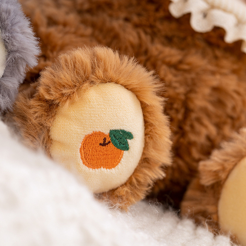 Shy bear plush toy paw detail with embroidered orange design soft texture stuffed animal close up