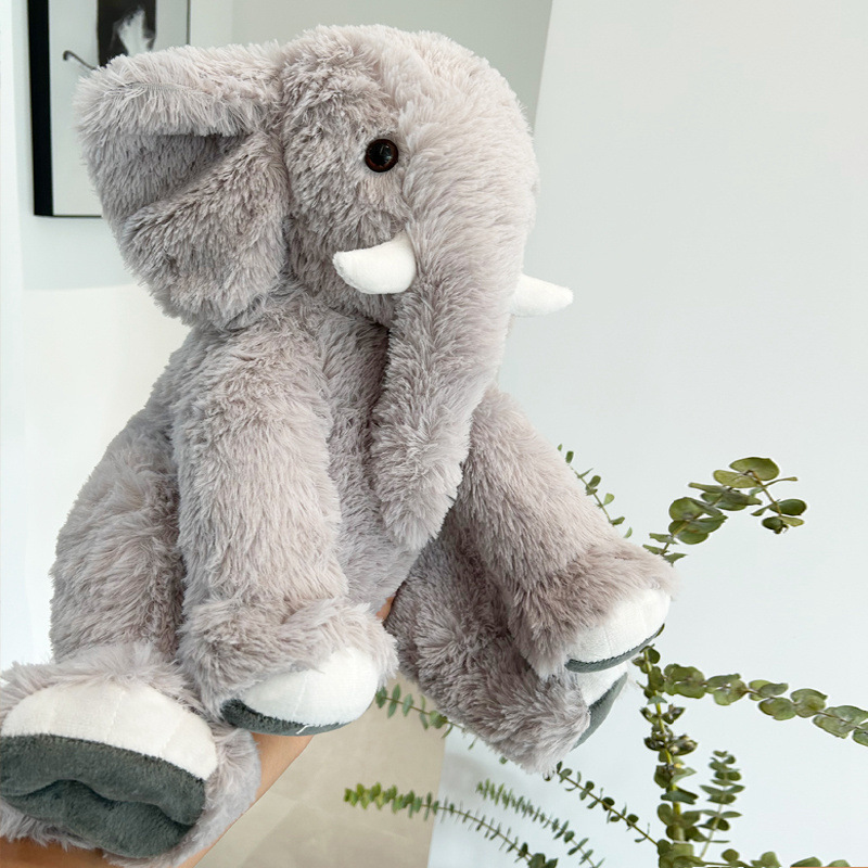 Gray elephant plush toy in a home setting, soft fluffy texture with detailed design and cozy decorative style