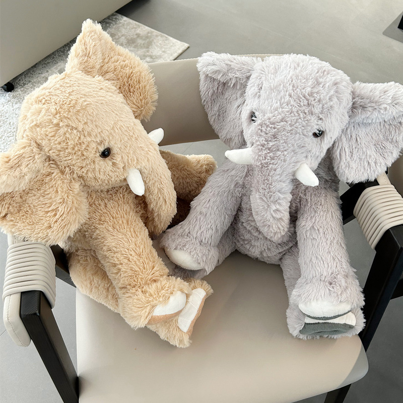 Soft elephant plush toys in neutral colors resting on a chair, fluffy texture and relaxed sitting design
