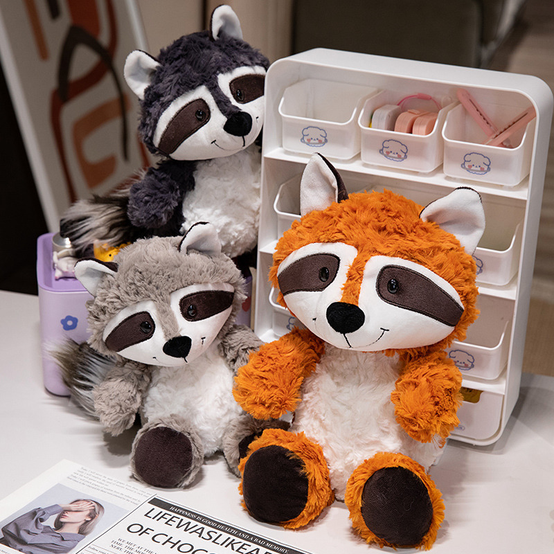 Raccoon plush toys in orange gray and dark gray soft stuffed animals displayed on desk for cozy home decor
