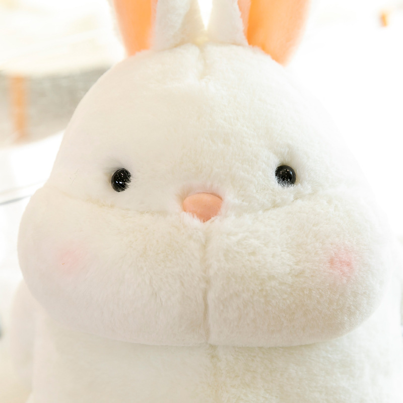Rabbit plush toy face close up with round shape, soft plush fabric and embroidered details, creating a cute and comforting companion for relaxing or decorating
