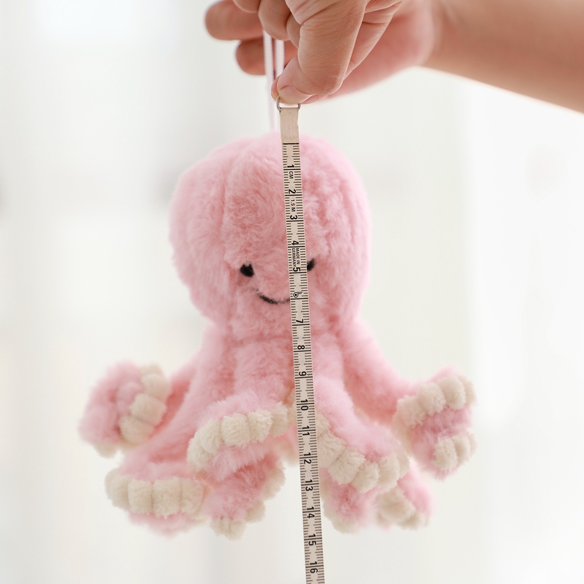 18 cm mini octopus plush toy measured with tape, small size soft stuffed animal with cute design and hanging loop