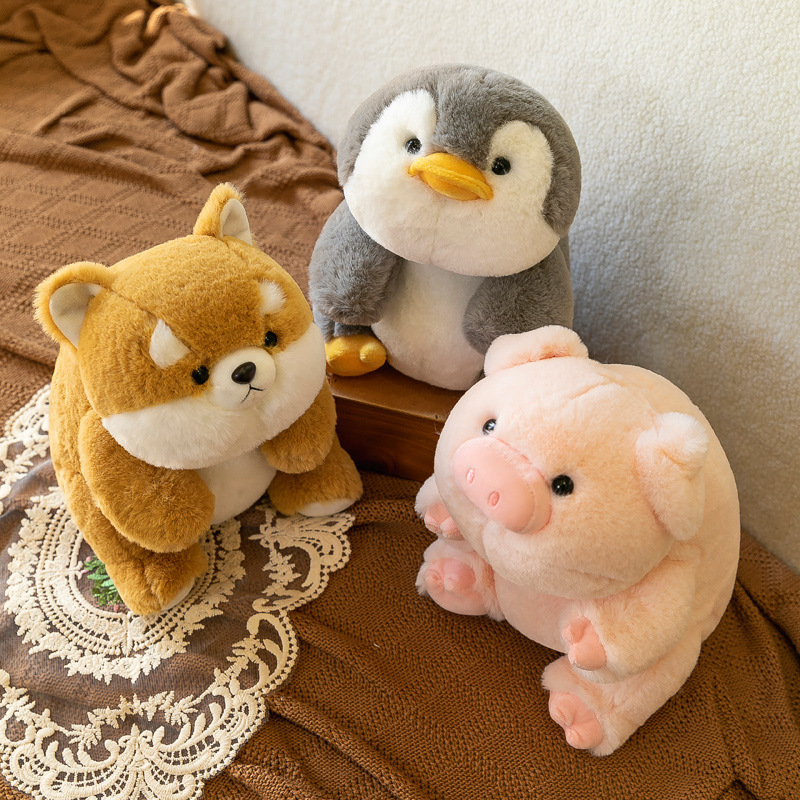 Shiba Inu, penguin and pig companion plush toys on sofa with soft plush texture, cozy setup for hugging and relaxing at home