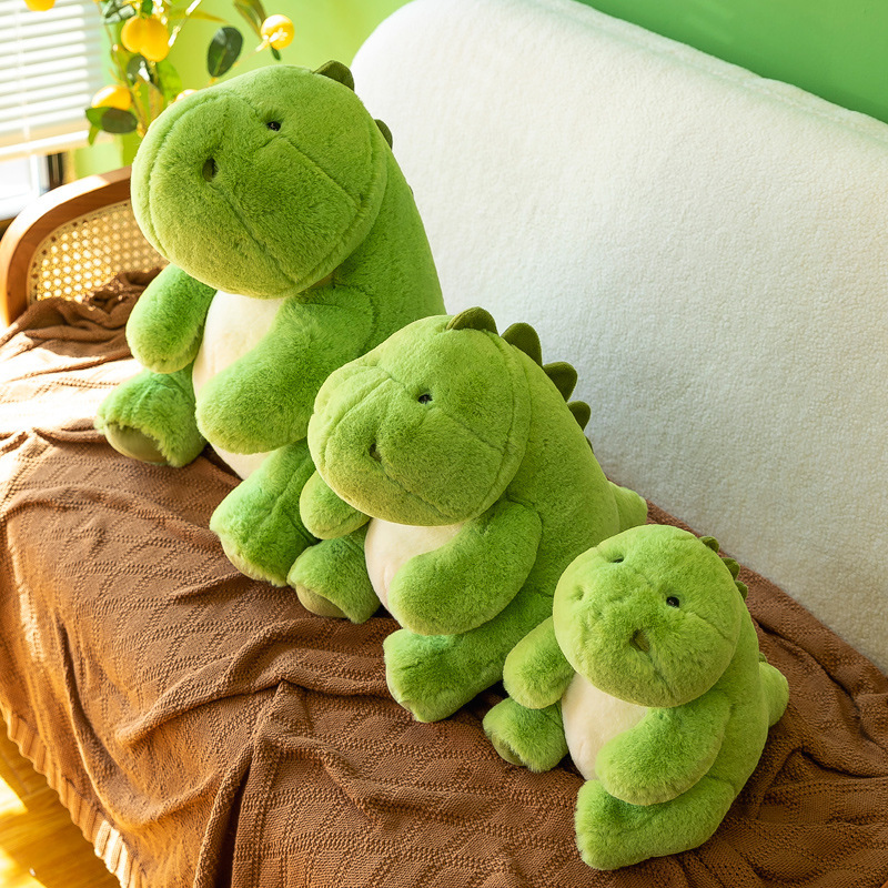 Green dinosaur companion plush toys on sofa with soft plush fabric, perfect for relaxing, hugging and adding a cozy atmosphere to living space
