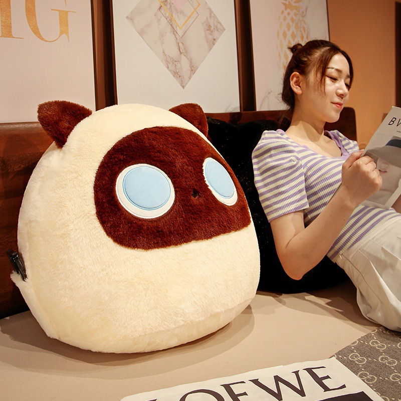 Beige round cat plush pillow as a cozy cushion for reading and relaxing on bed or sofa
