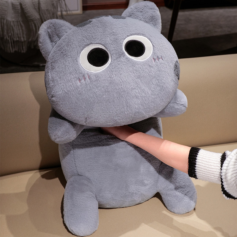 Gray long cat plush pillow being gently squeezed, soft and huggable stuffed body pillow with cute round face design