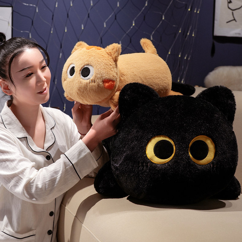 Black and orange long cat plush pillows being held, soft stuffed cat body pillows with cute round eyes for hugging and cozy bedroom decor