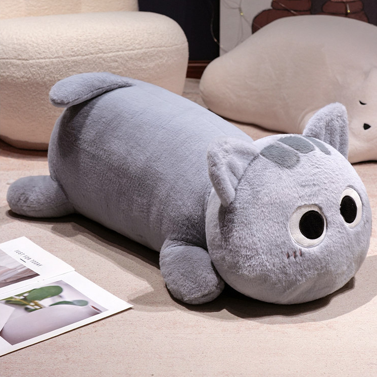 Gray long cat plush pillow lying on floor, soft stuffed cat body pillow with smooth plush texture for hugging and home decor