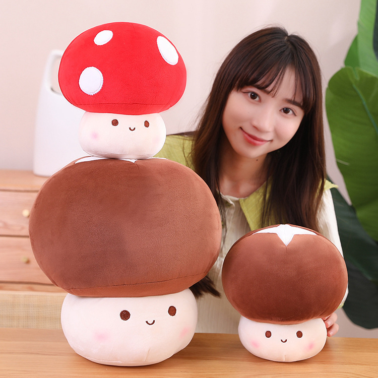 Stacked mushroom plush toys in red and brown colors showing size variation and soft texture, perfect for decorating sofas, beds, or adding a playful touch to any room