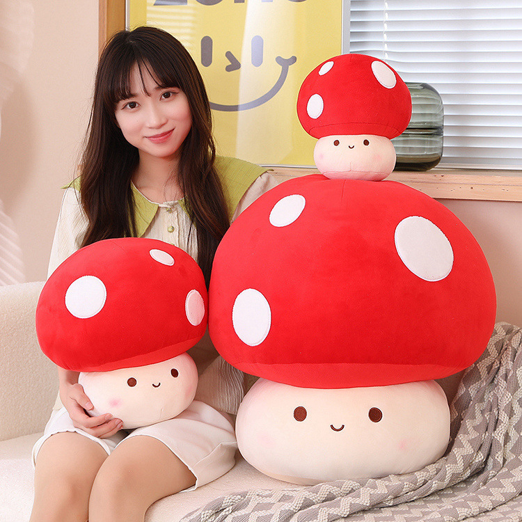 Mushroom plush toy in red color displayed on a sofa, showing its soft texture and cozy size for hugging, relaxing, or decorating a warm and cute living space