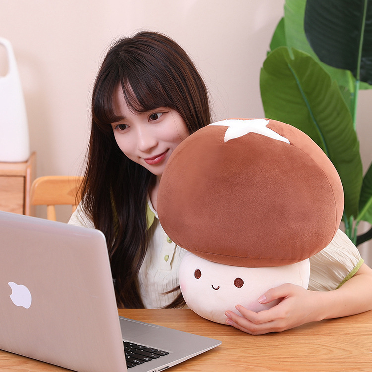 Brown mushroom plush toy placed on a desk beside a laptop, highlighting its soft and comforting design, suitable for relaxing, workspace decor, or daily use