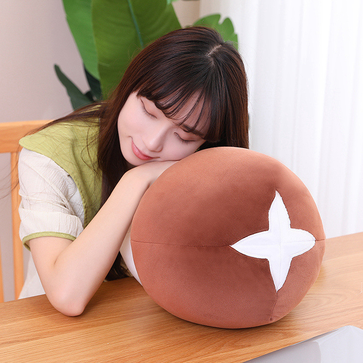 Soft brown mushroom plush toy used as a cushion on a desk, showcasing its cozy texture and comfort, ideal for resting, relaxing, or adding warmth to home spaces