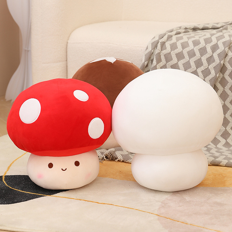 Red, white, and brown mushroom plush toys arranged on a sofa, showcasing different styles and colors, perfect for decorating bedrooms or creating a warm, playful atmosphere