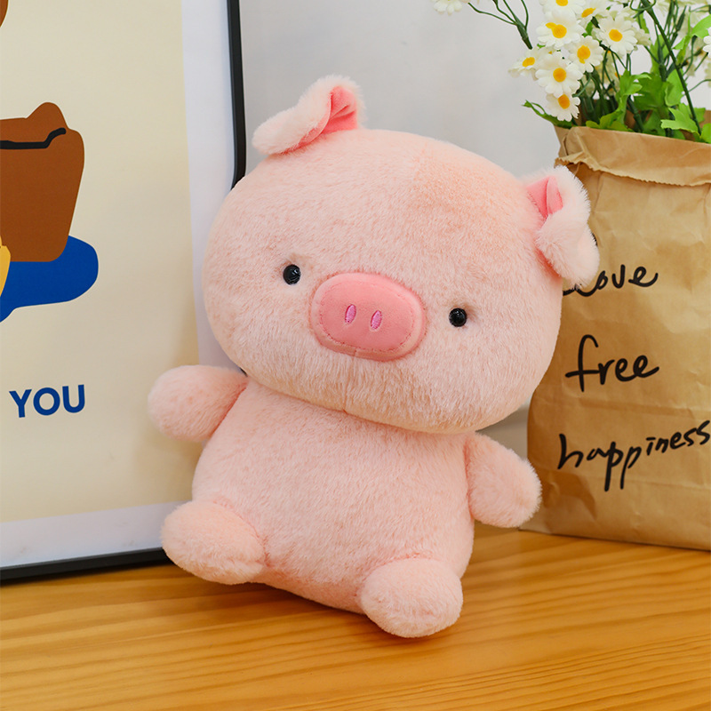 Pig plush toy with soft smooth fabric and rounded shape, displayed on a wooden table in a cozy home setting, perfect for decoration and cuddling