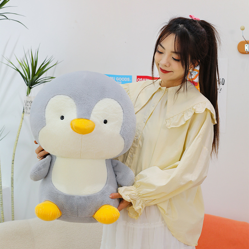Large penguin plush toy with soft smooth fabric and rounded shape, a cuddly stuffed animal ideal for hugging and cozy home comfort