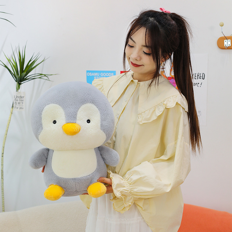 Penguin plush toy in a medium size with soft fabric and cute rounded shape, a cozy companion for cuddling and everyday comfort