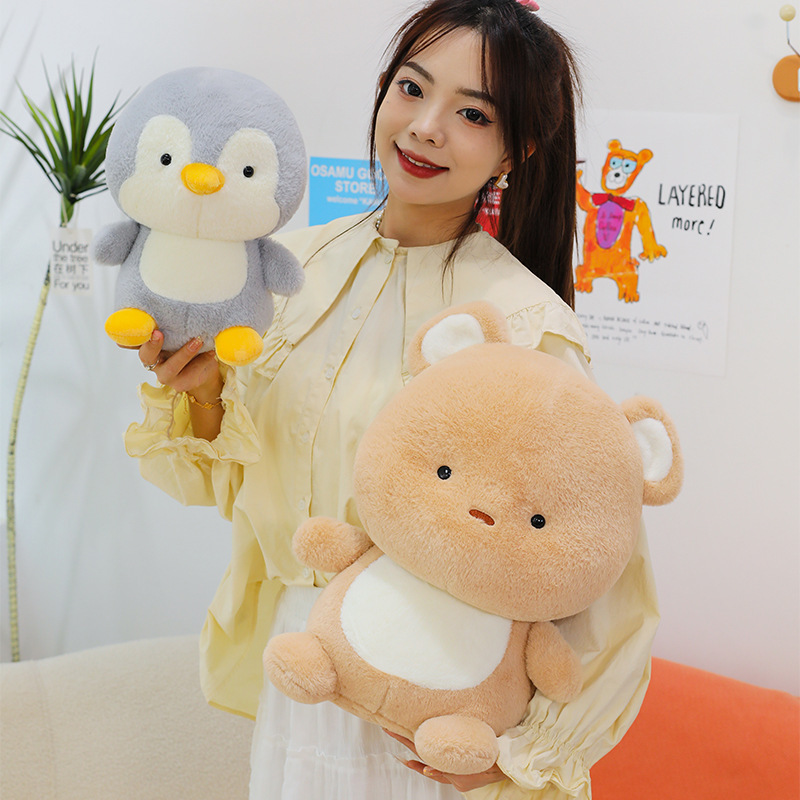 Penguin and bear plush toys with soft fabric and cute rounded shapes, perfect for cuddling, relaxing and decorating cozy home interiors