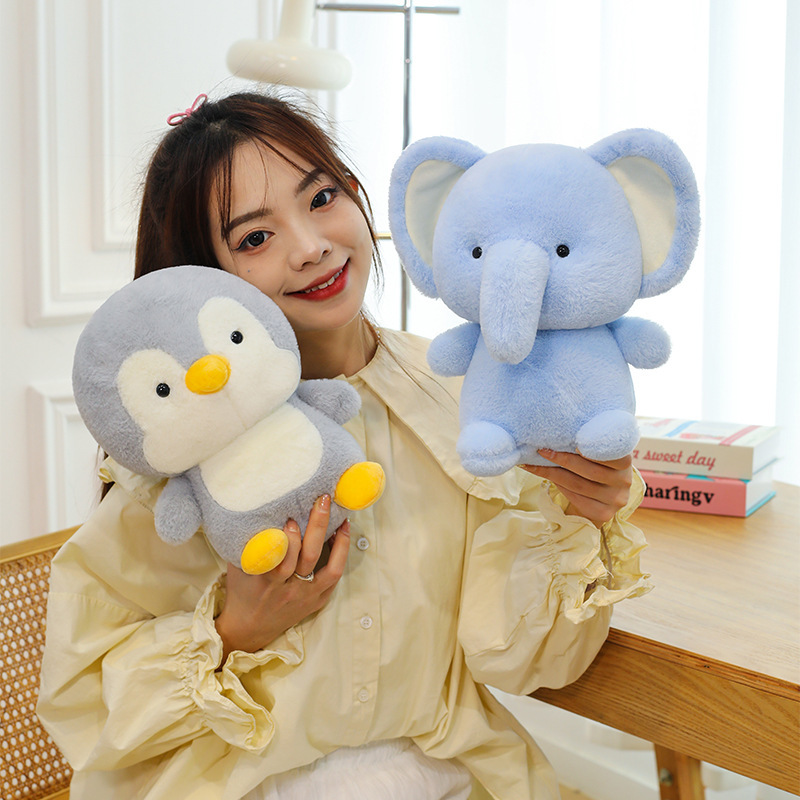 Penguin and elephant plush toys with soft smooth fabric and rounded shapes, cuddly stuffed animals ideal for hugging and cozy home comfort