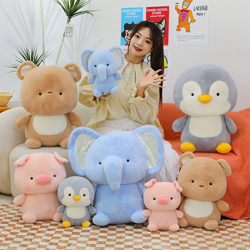 Animal plush toys including pig, bear, elephant and penguin displayed on sofa and floor, soft and cozy companions for home decor and relaxation