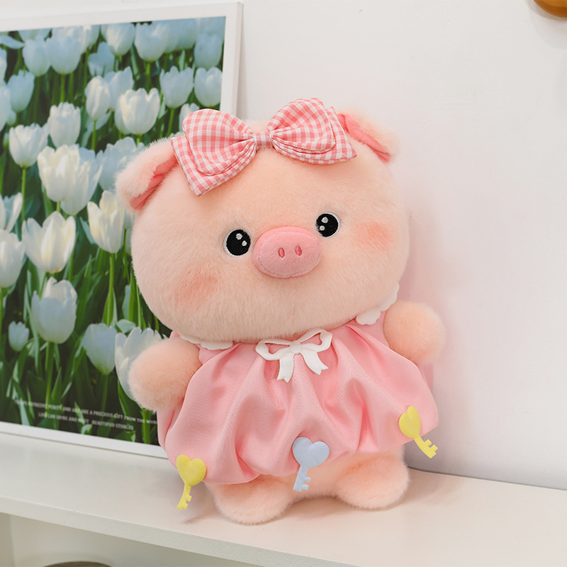 Bubble pig plush toy in pink dress with bow detail placed on shelf, soft plush texture and gentle colors, suitable for room decoration and cozy display