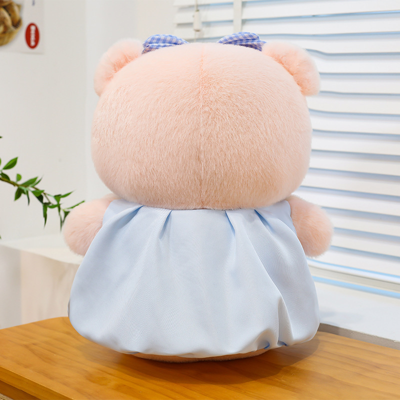 Bubble pig plush toy back view in blue dress, soft plush material and full rounded shape, showing stitching detail and overall design