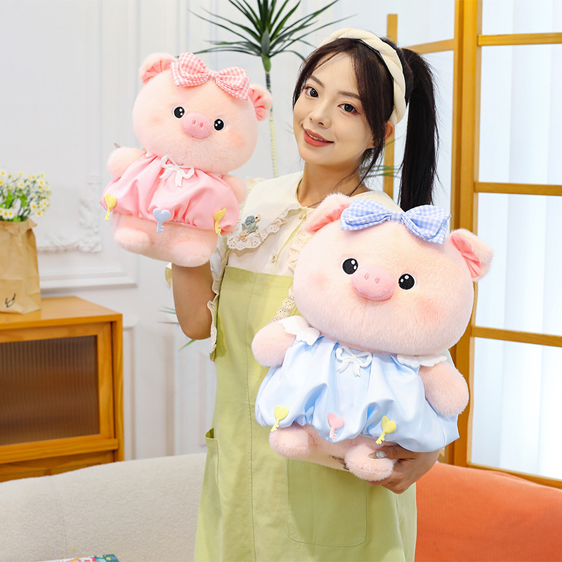 Bubble pig plush toys in pink and blue with bow dresses shown in different sizes, soft plush fabric and cuddly shape, suitable for hugging, gifting and room decoration